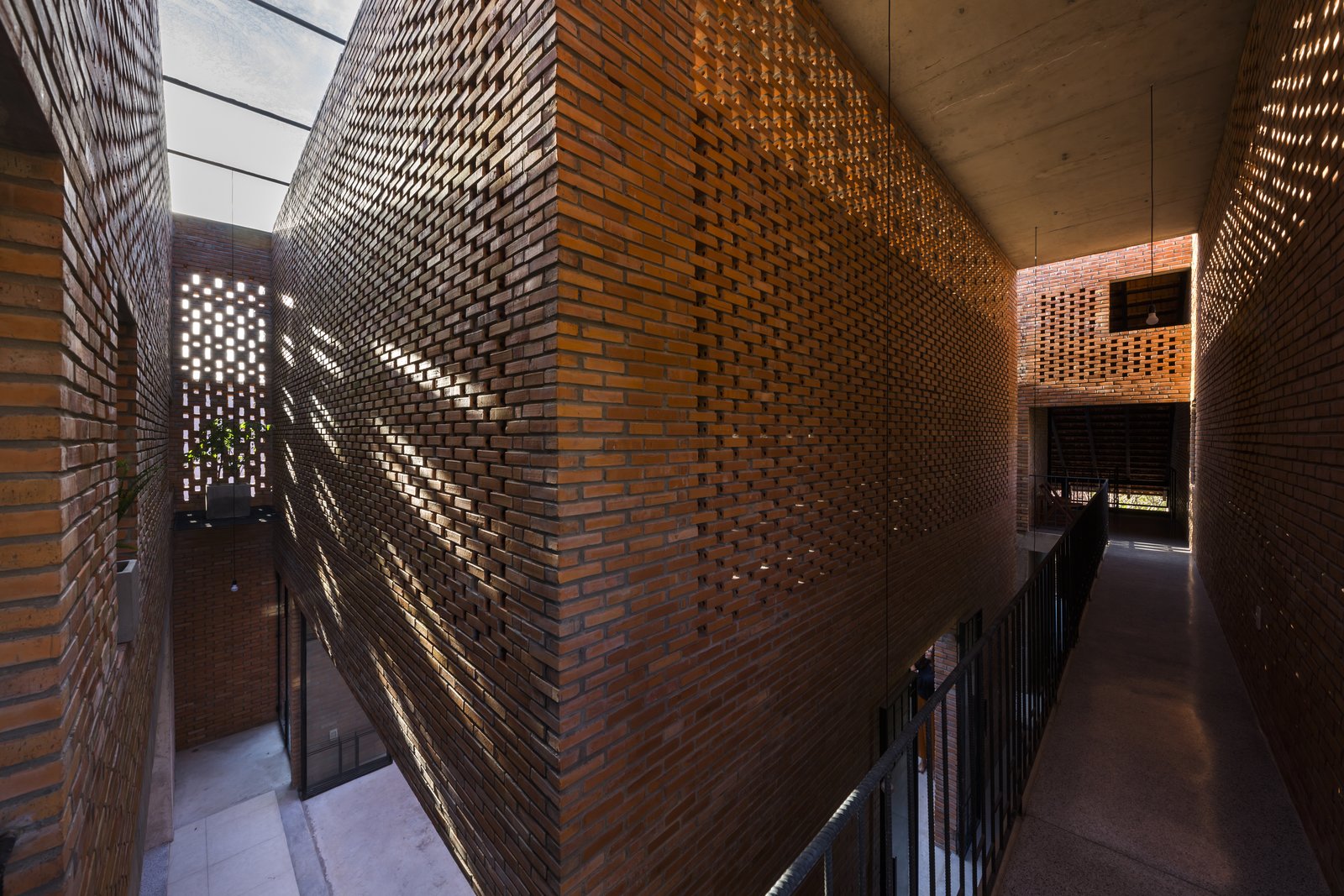 A corridor on the upper level connects the two roof structures.