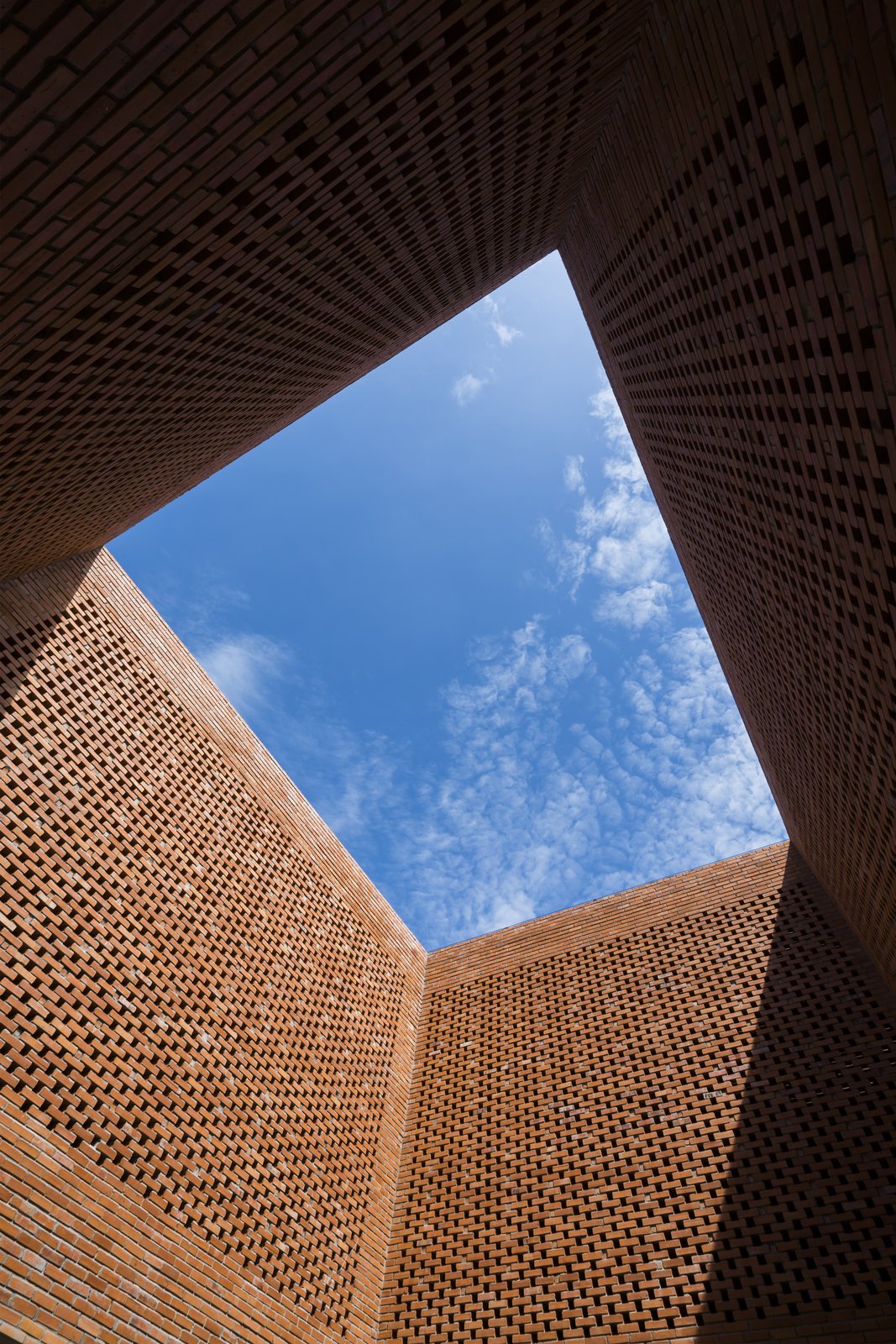 A large expanse of blue sky seen from the courtyard.