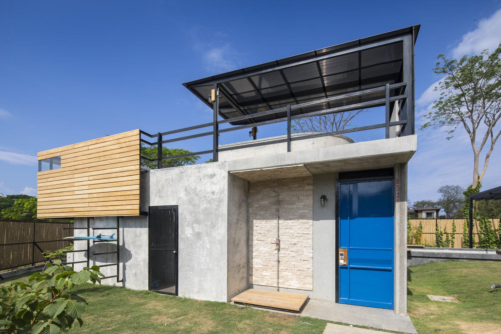 A smaller, rectangular building between the two blocks that's equipped for surfing-related activities.