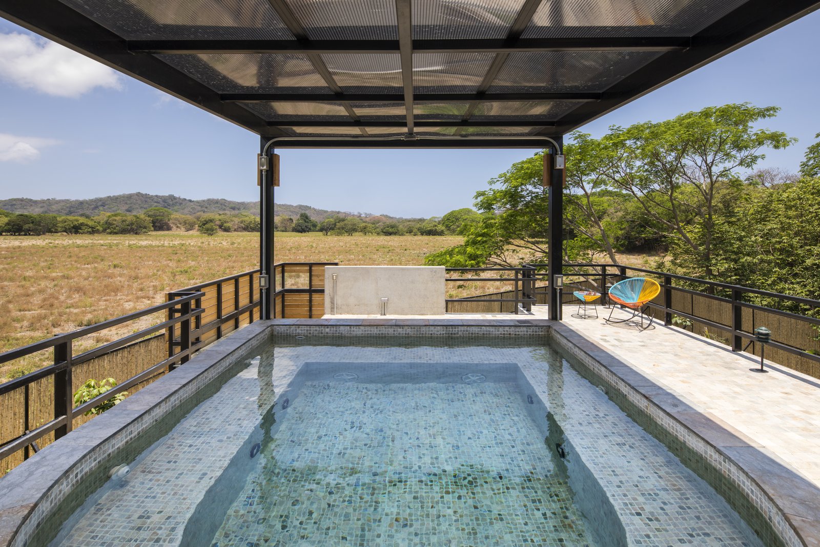 A plunge pool on the roof of the small building.