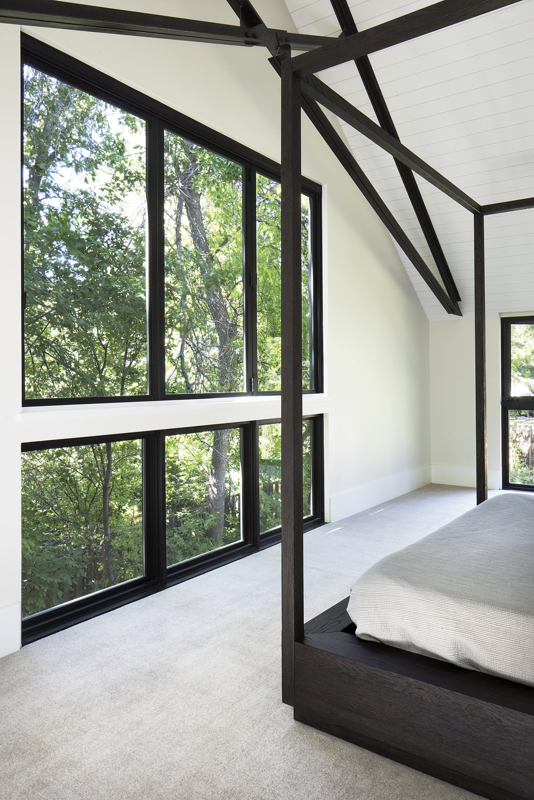 Inspired by historic farmhouses, beams are left exposed in the bedroom ceiling.