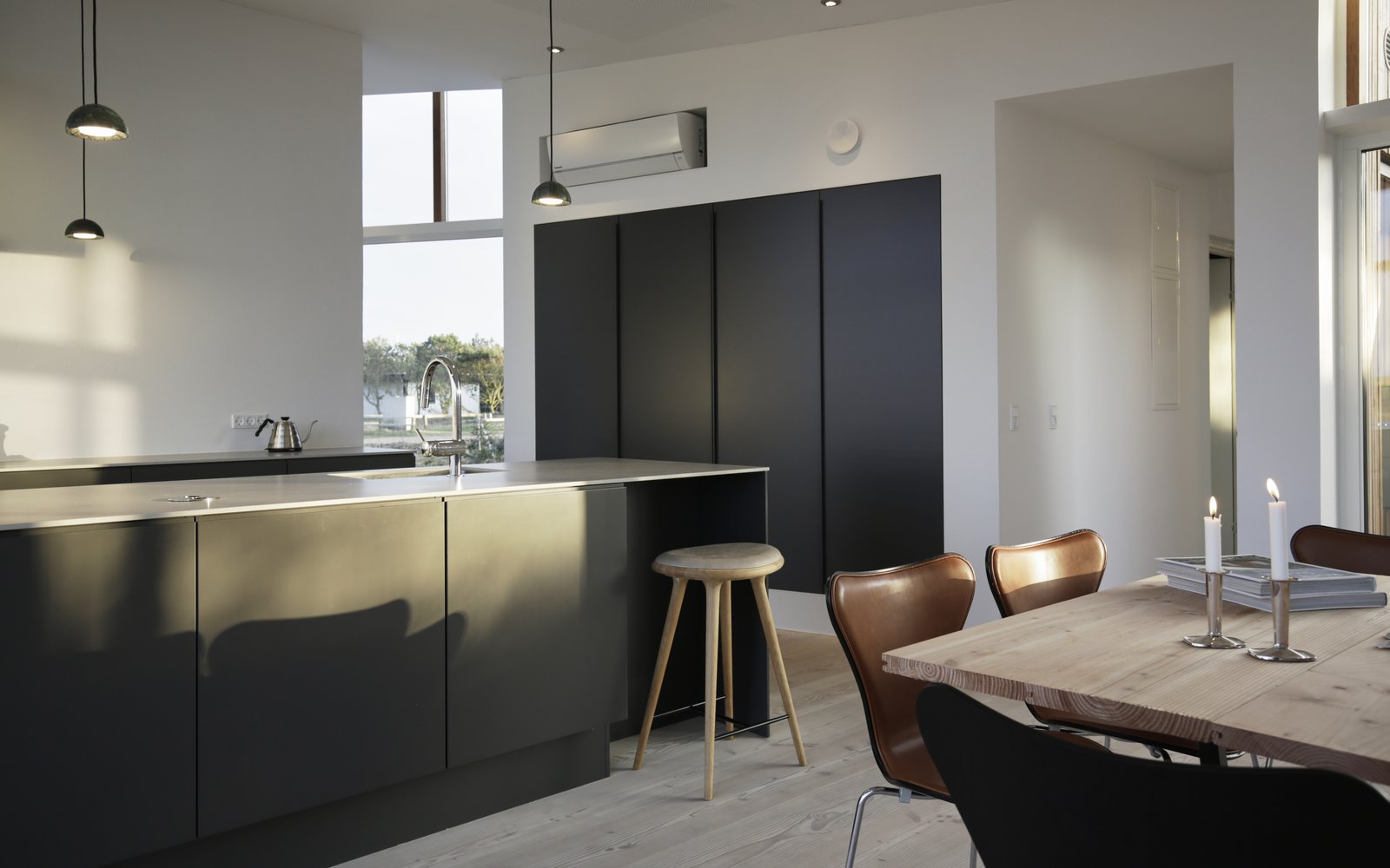A dark, streamlined kitchen in the open-plan living area.