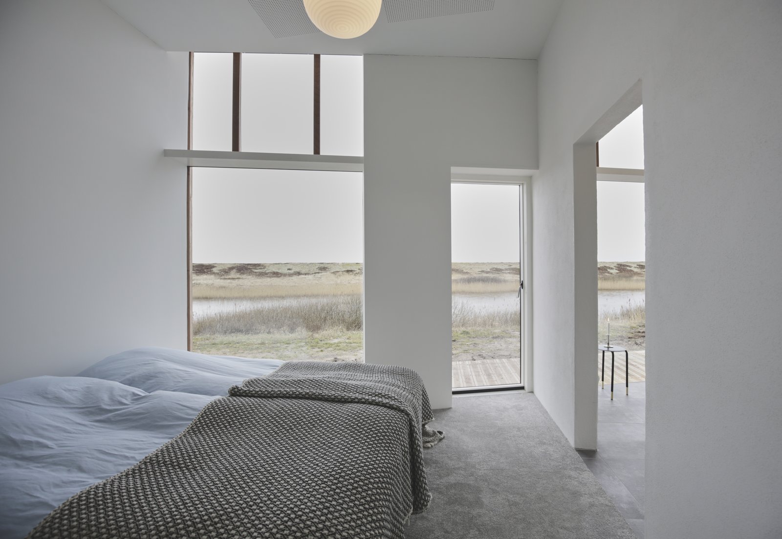 The lake-facing outdoor terrace can be accessed through the bedroom.
