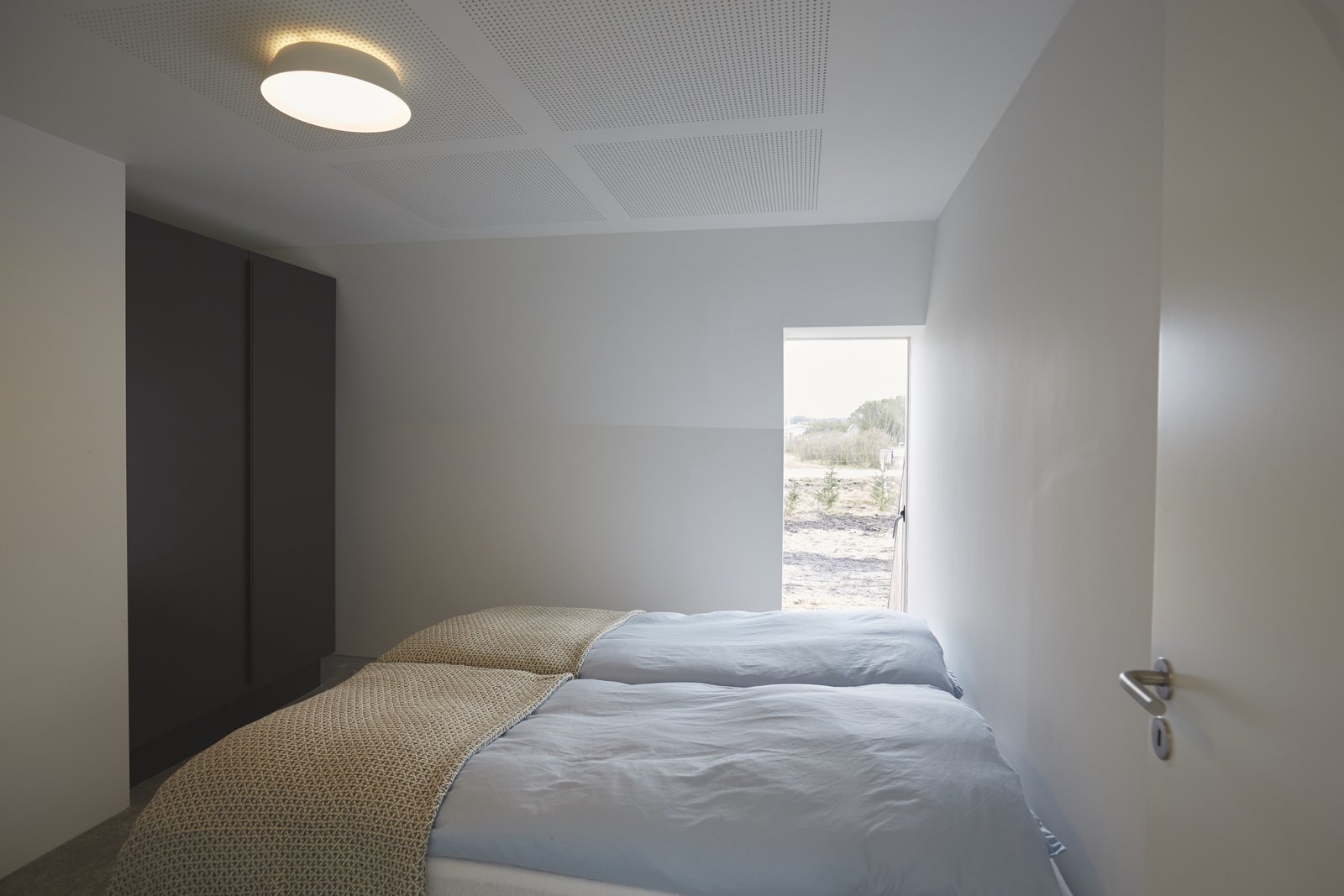 The comfy bedrooms are simply furnished.