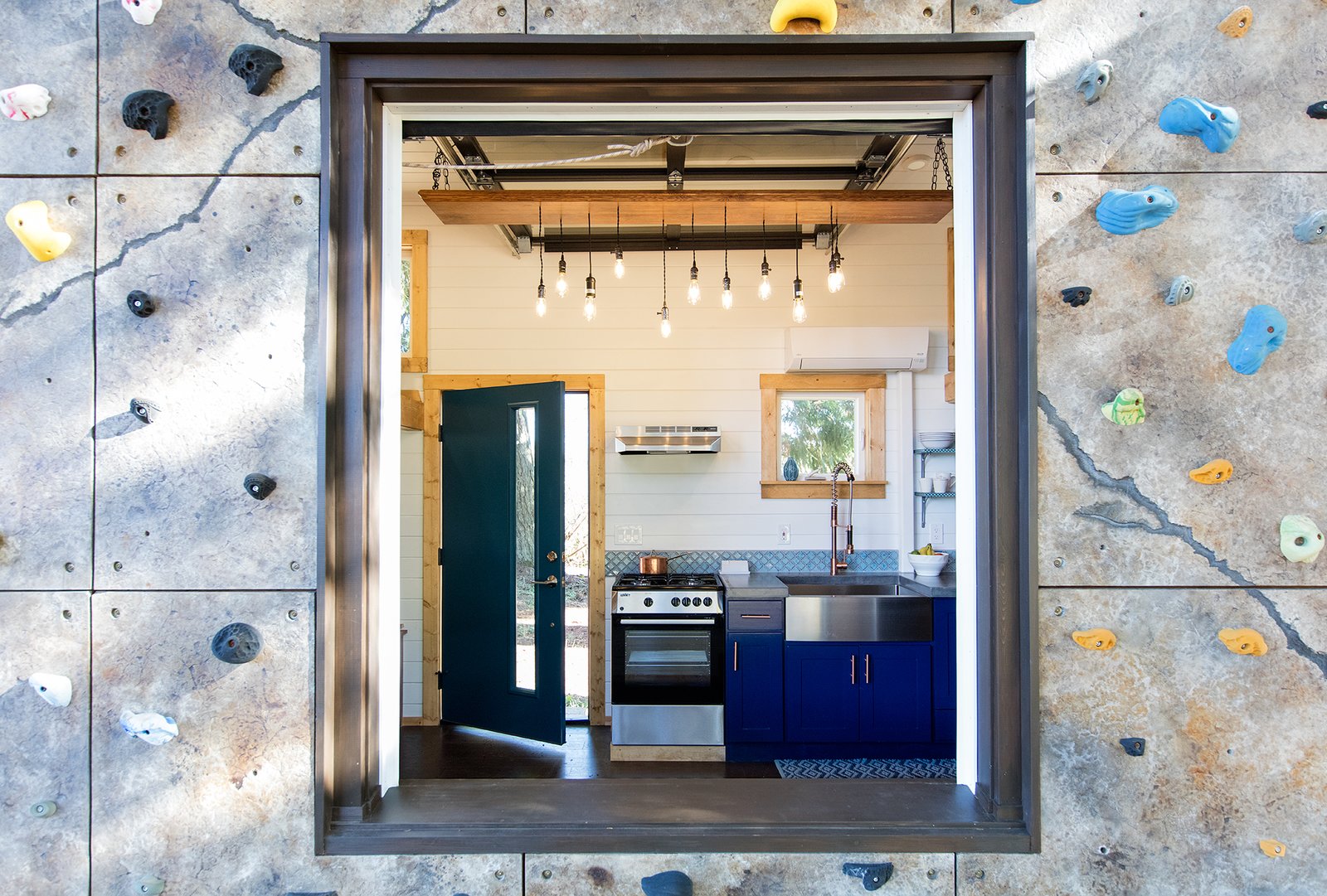 A large picture window that looks into the kitchen.