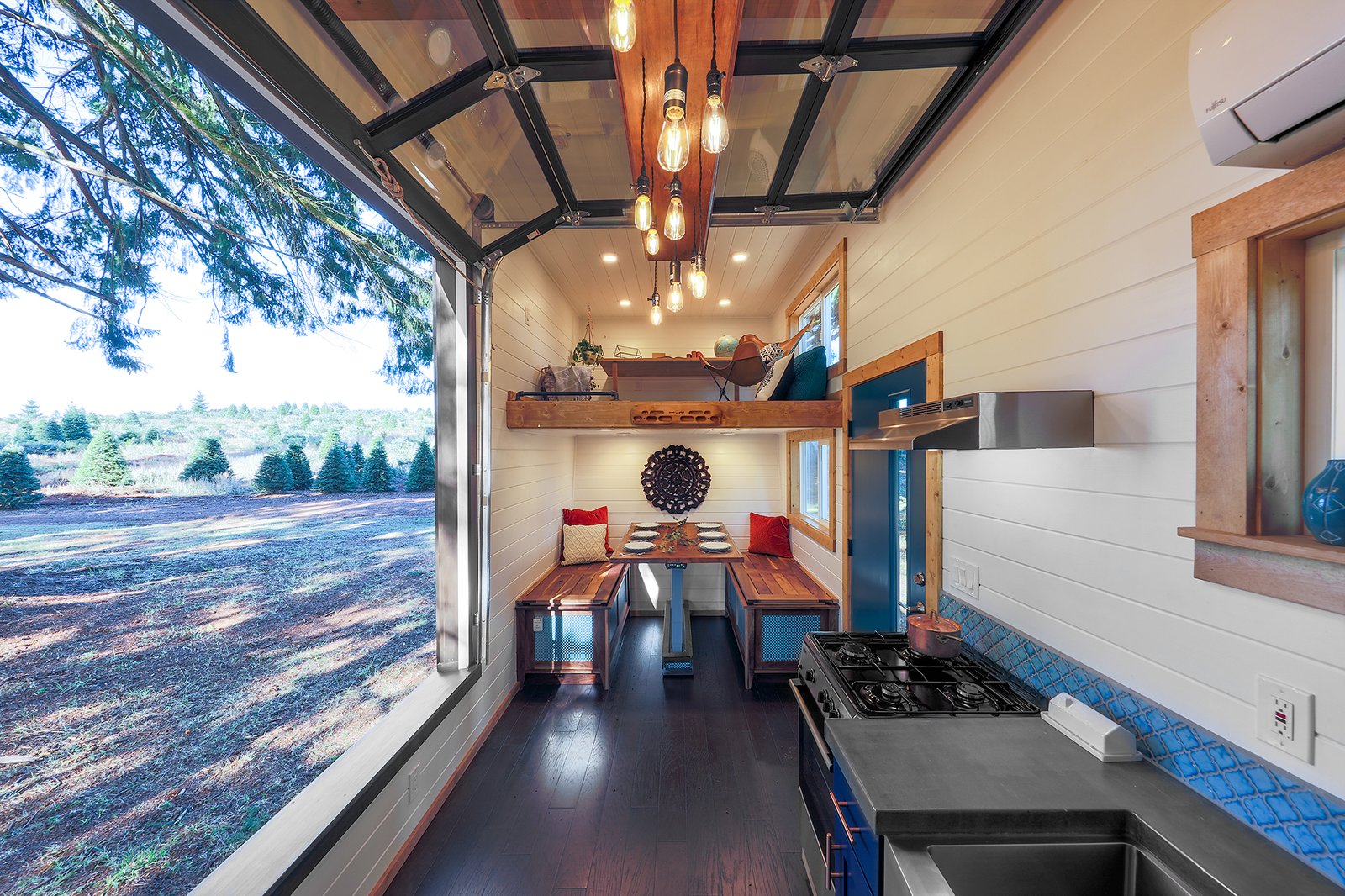 This built-in dining nook with a custom walnut dining table, and two benches can fit up to six people.