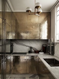 10 Dreamy Parisian Homes - Photo 3 of 10 - Going for Gold<br>A small Parisian kitchen