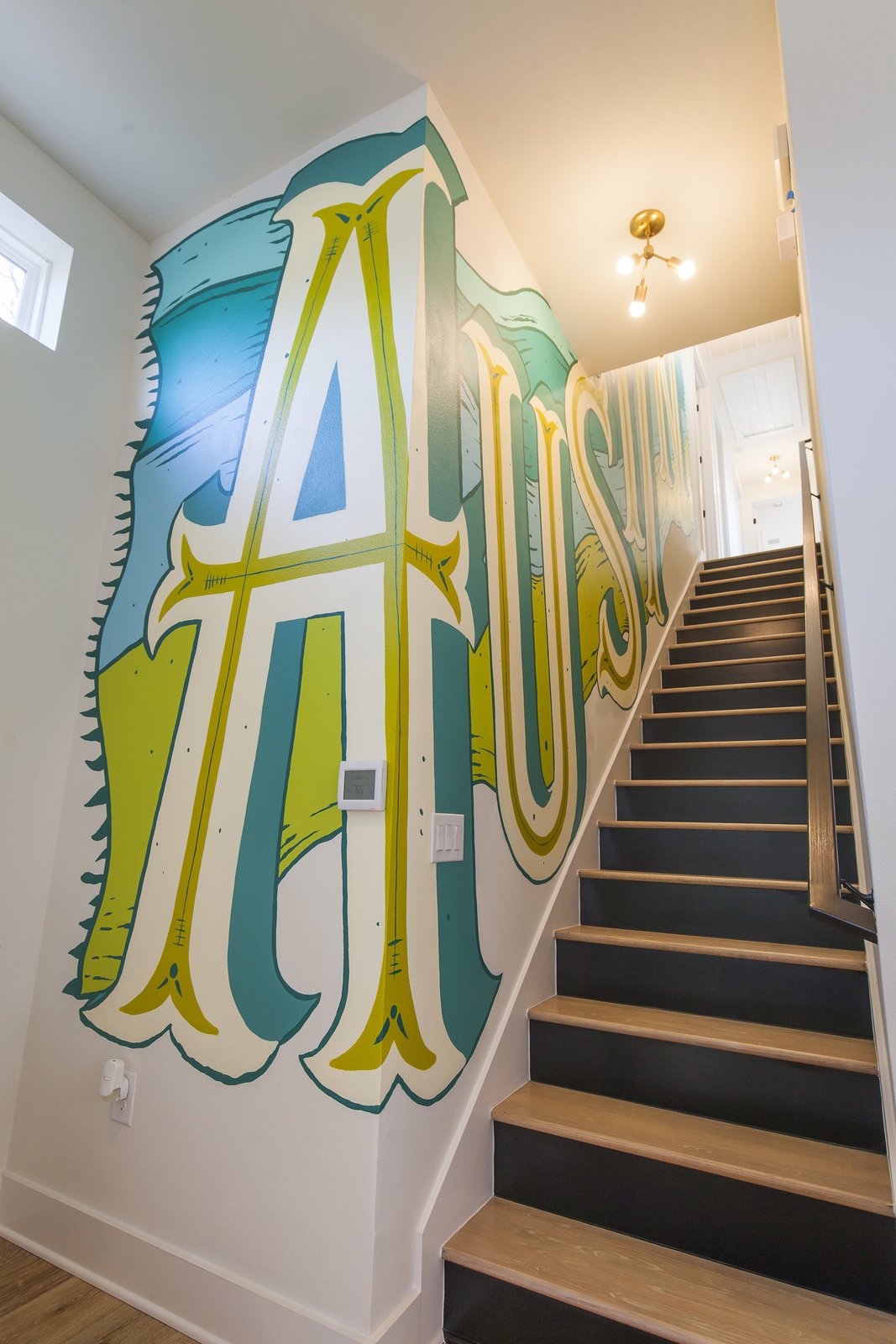Unit A - Stairwell - This is the custom mural we had designed for the staircase to keep things interesting but also invite some good ole' Austin charm into the house.