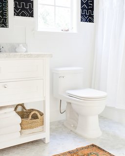 How to Prepare Your Bathroom for Overnight Guests - Photo 1 of 8 - A basket stored discreetly near the toilet keeps extra toilet paper out of sight but easily accessible; Source: Casa Tres