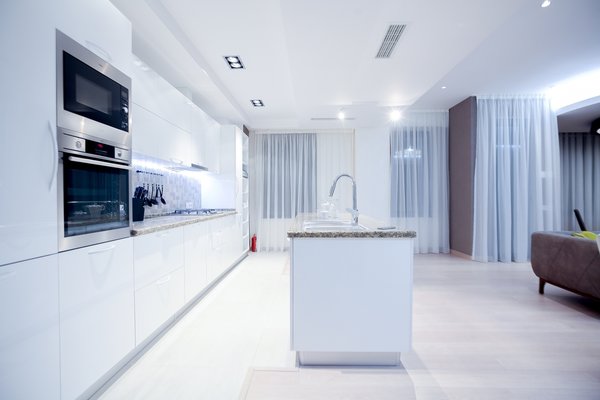 The house is spacious and the interior was designed in a manner, which kept this aspect highlighted: the entrance corridor leads to the large open area, uniting the kitchen, the living room and the dining room; The guest room wall, concealing the wardrobe, has two large incisions, making the wardrobe still part of the bedroom. Compelling design choice was also made for the master bedroom, where two sinks are not shying away from eye, but are rather put on display, as integral element of the bedroom.
Photo 17 of InnerEdges modern home