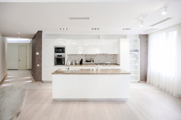 The house is spacious and the interior was designed in a manner, which kept this aspect highlighted: the entrance corridor leads to the large open area, uniting the kitchen, the living room and the dining room; The guest room wall, concealing the wardrobe, has two large incisions, making the wardrobe still part of the bedroom. Compelling design choice was also made for the master bedroom, where two sinks are not shying away from eye, but are rather put on display, as integral element of the bedroom.
Photo 2 of InnerEdges modern home
