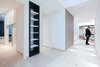 The house is spacious and the interior was designed in a manner, which kept this aspect highlighted: the entrance corridor leads to the large open area, uniting the kitchen, the living room and the dining room; The guest room wall, concealing the wardrobe, has two large incisions, making the wardrobe still part of the bedroom. Compelling design choice was also made for the master bedroom, where two sinks are not shying away from eye, but are rather put on display, as integral element of the bedroom.
Photo 5 of InnerEdges modern home
