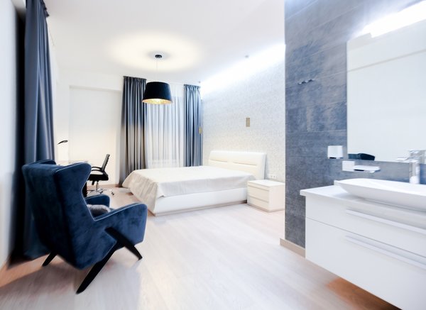 The house is spacious and the interior was designed in a manner, which kept this aspect highlighted: the entrance corridor leads to the large open area, uniting the kitchen, the living room and the dining room; The guest room wall, concealing the wardrobe, has two large incisions, making the wardrobe still part of the bedroom. Compelling design choice was also made for the master bedroom, where two sinks are not shying away from eye, but are rather put on display, as integral element of the bedroom.
Photo 11 of InnerEdges modern home