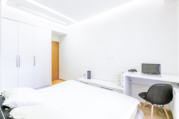 The low budget, family house project posed a challenge of conveniently arranging multiple rooms in small area. Pre-reconstruction edges of the walls were toned down, in order to conform to the new, minimalistic aesthetics and letting two colors prevail in the interior was also the part of the concept.
The white walls and the large mirrors make the space appear sizable. The wooden components of the interior bring a unifying ambience into play. The technical lighting illuminates the rooms without distracting the eye.
Photo 4 of PureLight modern home