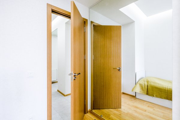 The low budget, family house project posed a challenge of conveniently arranging multiple rooms in small area. Pre-reconstruction edges of the walls were toned down, in order to conform to the new, minimalistic aesthetics and letting two colors prevail in the interior was also the part of the concept.
The white walls and the large mirrors make the space appear sizable. The wooden components of the interior bring a unifying ambience into play. The technical lighting illuminates the rooms without distracting the eye.
Photo 9 of PureLight modern home