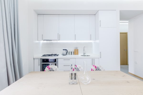 The low budget, family house project posed a challenge of conveniently arranging multiple rooms in small area. Pre-reconstruction edges of the walls were toned down, in order to conform to the new, minimalistic aesthetics and letting two colors prevail in the interior was also the part of the concept.
The white walls and the large mirrors make the space appear sizable. The wooden components of the interior bring a unifying ambience into play. The technical lighting illuminates the rooms without distracting the eye.
Photo 2 of PureLight modern home