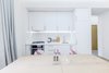The low budget, family house project posed a challenge of conveniently arranging multiple rooms in small area. Pre-reconstruction edges of the walls were toned down, in order to conform to the new, minimalistic aesthetics and letting two colors prevail in the interior was also the part of the concept.
The white walls and the large mirrors make the space appear sizable. The wooden components of the interior bring a unifying ambience into play. The technical lighting illuminates the rooms without distracting the eye.
Photo 2 of PureLight modern home