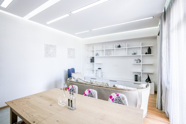The low budget, family house project posed a challenge of conveniently arranging multiple rooms in small area. Pre-reconstruction edges of the walls were toned down, in order to conform to the new, minimalistic aesthetics and letting two colors prevail in the interior was also the part of the concept.
The white walls and the large mirrors make the space appear sizable. The wooden components of the interior bring a unifying ambience into play. The technical lighting illuminates the rooms without distracting the eye.
Photo 3 of PureLight modern home