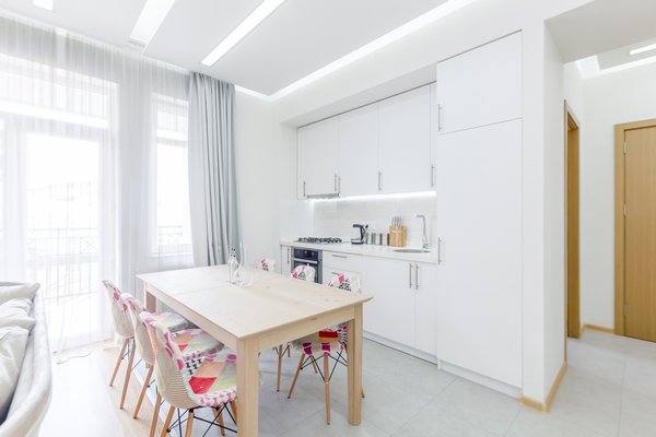 The low budget, family house project posed a challenge of conveniently arranging multiple rooms in small area. Pre-reconstruction edges of the walls were toned down, in order to conform to the new, minimalistic aesthetics and letting two colors prevail in the interior was also the part of the concept.
The white walls and the large mirrors make the space appear sizable. The wooden components of the interior bring a unifying ambience into play. The technical lighting illuminates the rooms without distracting the eye.
Photo 8 of PureLight modern home