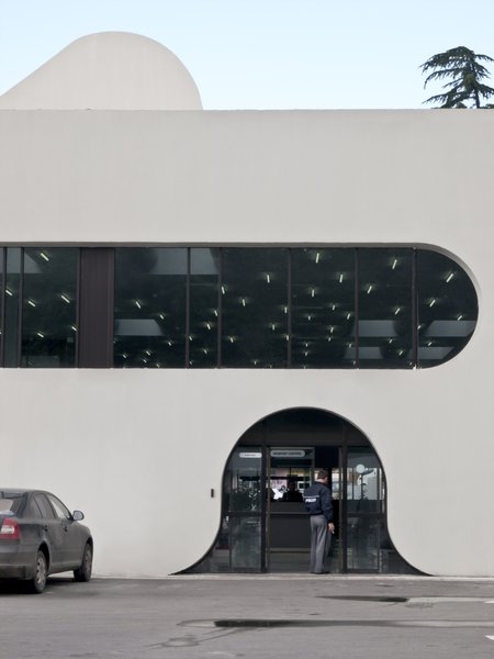 Sarpi border checkpoint is an architectural equivalent of a first impression. As a testament to this building being the entering point to Georgia, shape of the watchtower is inspired by the georgian lettering.
The customs hall for leaving Georgia is located closer to the seaside, than the one for entering the country and The duty free shop resides alongside to it.
The interior design is minimalistic in terms of both, forms and colors, amplifying the focus on functionality.
Architect's note: 'This project came with tight deadline and required meticulously thought-out planning of construction process, as it had to be put to use before the final completion of the building. Implementing interior design was particularly fulfilling experience for me.
My involvement in Sarpi border checkpoint and Mestia Airport projects served as a stepping stone for me, in terms of working independently as an architect and being more audacious in executing my personal architectural concepts that seemed way more challenging before.'
Photo 3 of Sarpi Border Checkpoint modern home