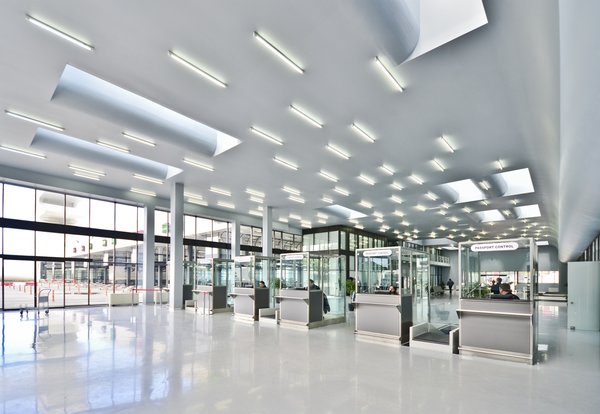 Sarpi border checkpoint is an architectural equivalent of a first impression. As a testament to this building being the entering point to Georgia, shape of the watchtower is inspired by the georgian lettering.
The customs hall for leaving Georgia is located closer to the seaside, than the one for entering the country and The duty free shop resides alongside to it.
The interior design is minimalistic in terms of both, forms and colors, amplifying the focus on functionality.
Architect's note: 'This project came with tight deadline and required meticulously thought-out planning of construction process, as it had to be put to use before the final completion of the building. Implementing interior design was particularly fulfilling experience for me.
My involvement in Sarpi border checkpoint and Mestia Airport projects served as a stepping stone for me, in terms of working independently as an architect and being more audacious in executing my personal architectural concepts that seemed way more challenging before.'
Photo 10 of Sarpi Border Checkpoint modern home