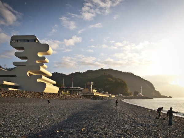 Sarpi border checkpoint is an architectural equivalent of a first impression. As a testament to this building being the entering point to Georgia, shape of the watchtower is inspired by the georgian lettering.
The customs hall for leaving Georgia is located closer to the seaside, than the one for entering the country and The duty free shop resides alongside to it.
The interior design is minimalistic in terms of both, forms and colors, amplifying the focus on functionality.
Architect's note: 'This project came with tight deadline and required meticulously thought-out planning of construction process, as it had to be put to use before the final completion of the building. Implementing interior design was particularly fulfilling experience for me.
My involvement in Sarpi border checkpoint and Mestia Airport projects served as a stepping stone for me, in terms of working independently as an architect and being more audacious in executing my personal architectural concepts that seemed way more challenging before.'
Photo 11 of Sarpi Border Checkpoint modern home