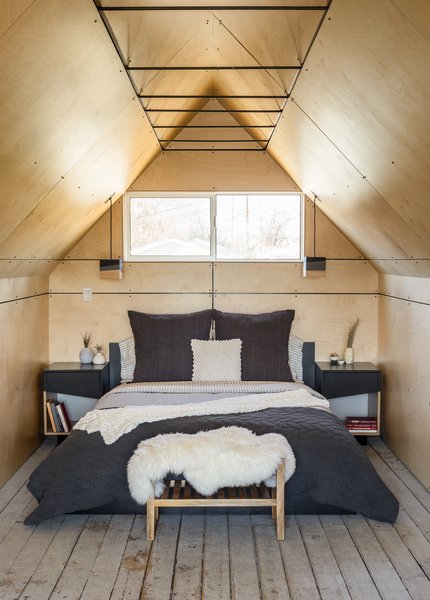 Modern home with bedroom, light hardwood floor, night stands, bed, and pendant lighting. Bedroom - Birch Wall and Ceiling Panels. Lights and Nightstands by Platform Workshop. www.platformworkshop.com Photo 6 of Blacksmith Shop