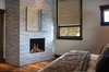 In the master bedroom, Michael and Eric decided on the perfectly proportioned Modore 75H modern gas fireplace by Element4. Living in the mountains of Colorado it’s only natural that Michael’s design sense draws from nature. You can see this influence in the natural fur bed spread, weathered wood floors and hand-picked tiles used to surround the modern fireplace. Photo of Breckenridge Bliss modern home