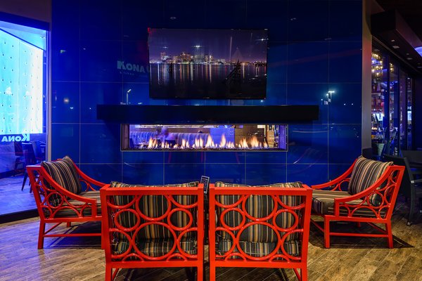 EH: And why did you pick the Tenore 240 by Element4 — a double-sided, see-through fireplace for this space?
SA: "Like I said, I like to create different dining experiences within the same space while maintaining the connectivity and energy throughout. The double sided fireplace allows more visibility between the wall and gives more bang for the buck, allowing a single unit to create two completely different atmospheres on either side. The appeal is to have division between the patio and dining room but still being able to see through to each and have the dynamic fire feature to combine the two." Photo 3 of Kona Grill modern home