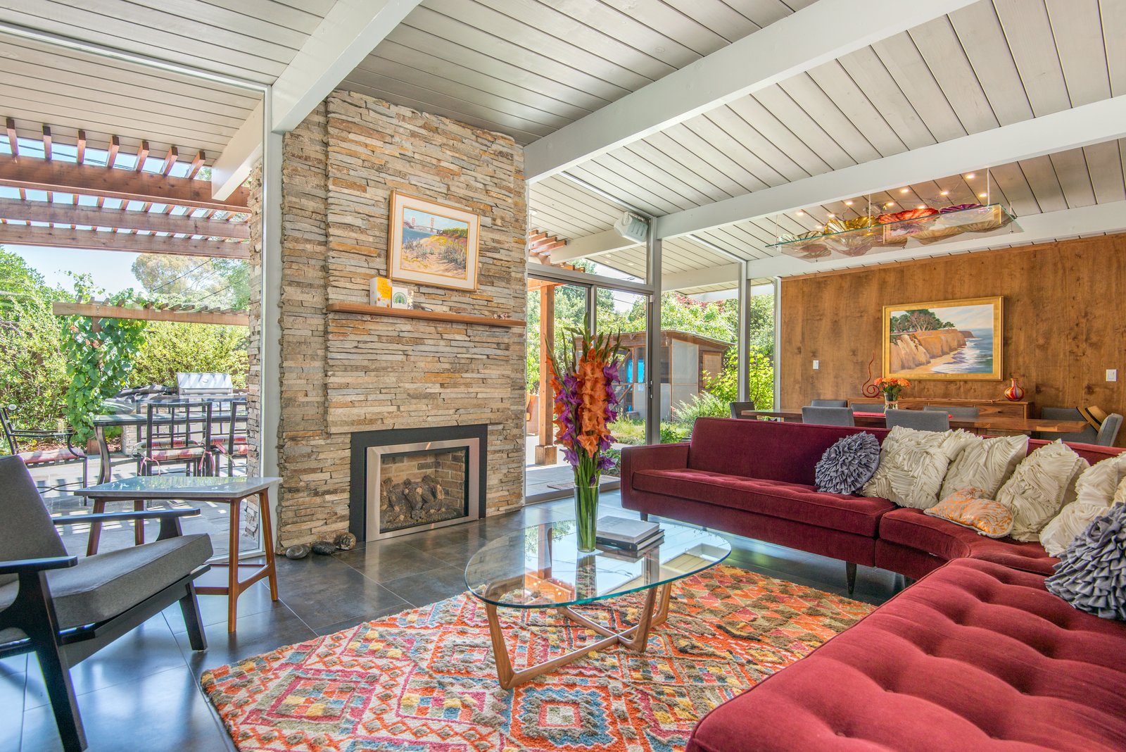 The living room lets the outdoors in. Furniture by Room and Board