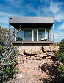The metal panels on this home provide durable protection in this harsh environment. The interior is kept cool by implementing a reflective outer surface, deep covered patios and plenty of opportunities for cross-ventilation.