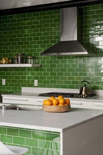 How the Colors in Your Kitchen Affect Your Appetite - Photo 11 of 11 - Stem green subway tiles, crisp against white marble countertops, unite this kitchen's island and galley counter.