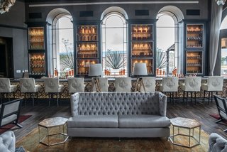 Patrón Designed a Spanish Colonial Guest House with Modern Flair - Photo 6 of 14 - One of the interior sitting rooms at La Casona; the space feature marble tables and bar tops from Marble Gris Coral and Marble Veracruz from Puebla, Mexico.