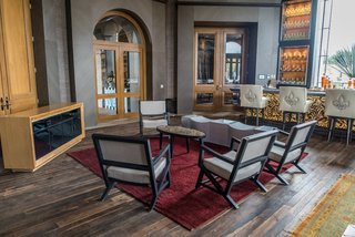 Patrón Designed a Spanish Colonial Guest House with Modern Flair - Photo 7 of 14 - The floors are made from reclaimed wood found in the local region; the chairs are upholstered in American and Spanish textiles. 