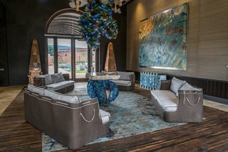Patrón Designed a Spanish Colonial Guest House with Modern Flair - Photo 8 of 14 - 16' 6" ceilings allowed for oversized chandeliers to be used in community spaces; Mexican and modern design are expertly juxtaposed through wood and hand-blown glass. 