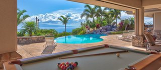 10 Dream Modern Home Rentals In Hawaii - Photo 5 of 10 - Rainbow Estate is a luxurious vacation rental located in Maui, hosting gorgeous Pacific Ocean views. This four bedroom estate has an ability to sleep up to 10 guests in comfort, surrounded by a host of fun vacation amenities. The king master suite is divine with a deluxe en suite bathroom and complete privacy. The two private queen suites are lovely and share a luxurious bathroom. The fourth bedroom is loft-style with two double beds; perfect for children, and adjacent to the indoor movie theater. 