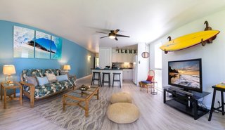 10 Dream Modern Home Rentals In Hawaii - Photo 9 of 10 - No trip to Hawaii is complete without exploring the surfer culture and lifestyle, or even having a go yourself at this "sport of kings", which originated itself on the islands. If you want to stay in a place that embodies all the charm and energy of the North Shore lifestyle, this 1 bedroom 1 bath, with enclosed, spacious lanai is the perfect place to get away from it all. If you happen to like some turf with your surf, the apartment looks out to the renowned Arnold Palmer 19-hole golf course and a charming cluster of mature banyan trees.