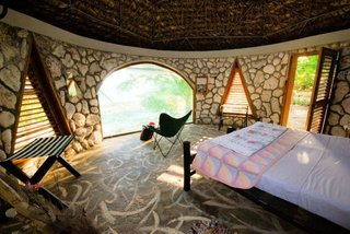 14 Really Romantic Island Resort Retreats - Photo 5 of 15 - Jackie’s was created as a small temple of no particular faith and is an eco-friendly, locavore environment amidst organic gardens overlooking 180 degrees of the majestic Caribbean Sea. The Dome is their newest addition: sleep in a stone geodesic dome right on the sea. The design was created by Buckminster Fuller. After being destroyed by hurricane Ivan in 2004, the Dome was reconstructed using corals.