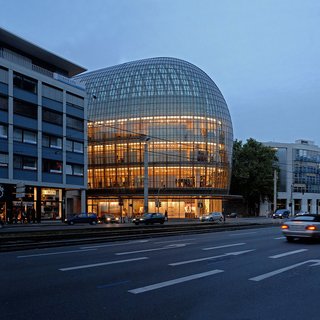 12 Renzo Piano Buildings We Love - Photo 3 of 12 - As a landmark in the city of Cologne, the curved front facade of this distinctive department store cantilevers subtly out into the area's pedestrian zone, strengthening the presence of the store along a major pedestrian and shopping axis.