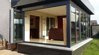 Great Britain-based Budget Conservatories (while bringing a certain sophistication with the British word for sunroom) calls this modern-looking addition a "Conservatory Pod", and demonstrate in the video below the removal of a traditional conservatory and replacement with one of their beautiful Pods. 