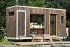 Modern home with Wood Siding Material, Green Roof Material, House, and Exterior. The Sturgis sits on a custom galvanized steel foundation with removable wheels and hitch, so it can be easily transported to site and then dropped directly on the ground, removing the need for a crane or big crew. The modular aluminum and garapa deck can be expanded or reconfigured with just two people. Photo 4 of The Sturgis