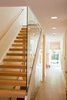 Once inside the home, you are greeted in the entry hall immediately exposing to view a three-story stairwell incorporating a glass wall running the entire height. This first impression informs all visitors that this is not an old farmhouse. It was a deliberate juxtaposition to create a more contemporary and modern interior element as the unexpected design moment for this classic dwelling. Photo 3 of Urban Farmhouse modern home