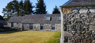 Merging Old and New With These 10 Modern Renovations in Scotland - Photo 7 of 10 - Finished in 2010, Glasgow-based Dualchas Architects converted a former L-shaped byre into a live/work space for a printmaker and textile designer. While interior concrete walls divide the working and living spaces and new windows and skylights bring in additional light, they still managed to preserve the original character of the structure.