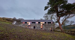 Merging Old and New With These 10 Modern Renovations in Scotland - Photo 9 of 10 - Another home by WT Architecture, The Mill is a former threshing mill that was transformed into a modern vacation home. Abandoned for 70 years prior to its renovation, the structure required significant work. The majority of the interior spaces are open-concept and lined with plywood and pine planks, and additional windows allow for views to the valley. 