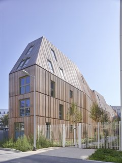 Guide to 7 Main Types of Roofs and What You Need to Know About Them - Photo 6 of 15 - French design studio Tetrarc designed a series of modern apartment buildings inspired by the classic Haussman-era buildings in Paris with sloped mansard-style roofs—but he constructed it with elongated proportions and modern materials.