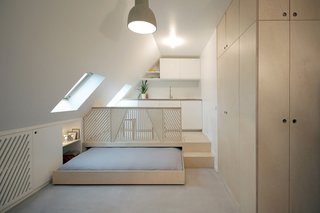 Guide to 7 Main Types of Roofs and What You Need to Know About Them - Photo 7 of 15 - A mansard-roofed Parisian apartment was renovated by Batiik Studio to incorporate millwork and cabinetry that was custom-built for the sloped walls of the attic space.