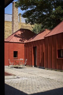 Guide to 7 Main Types of Roofs and What You Need to Know About Them - Photo 9 of 15 - Hip roofs of different heights and proportions are united by a consistent use of metal cladding in a London project by Henning Stummel Architects.