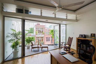 5 Architectural Tricks and Devices to Bring Natural Light Into Your Home - Photo 4 of 12 - In this house in Thailand by Mel Schenck, a light shelf with translucent louvers above helps to regulate the bright light that enters from the outside porch.