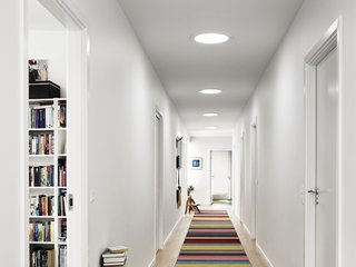 5 Architectural Tricks and Devices to Bring Natural Light Into Your Home - Photo 7 of 12 - A series of three sun tunnels, or sun pipes, brighten up a windowless corridor.