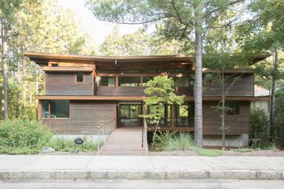 An Eco-Friendly Community Outside of Atlanta Celebrates Nature and Sustainability - Photo 7 of 10 - Front yards with older and newer trees create privacy, while granite curbs along the sidewalk indicate the community's attention to quality and detail.